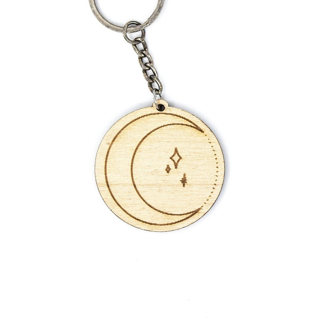 Wooderland round wooden moon keyring with engraved crescent moon and star design on a metal keychain ring.