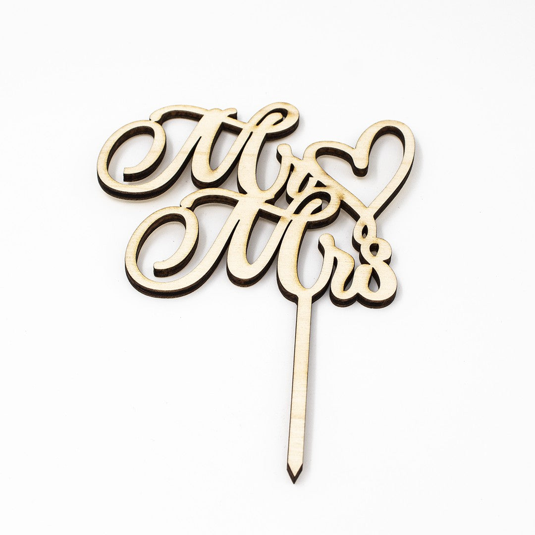 Wooderland laser-cut wooden Mr & Mrs wedding cake topper with elegant script and heart detail on white background